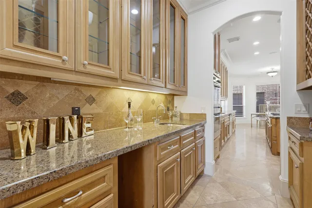 view of a kitchen with granite countertop a sink and a counter top space