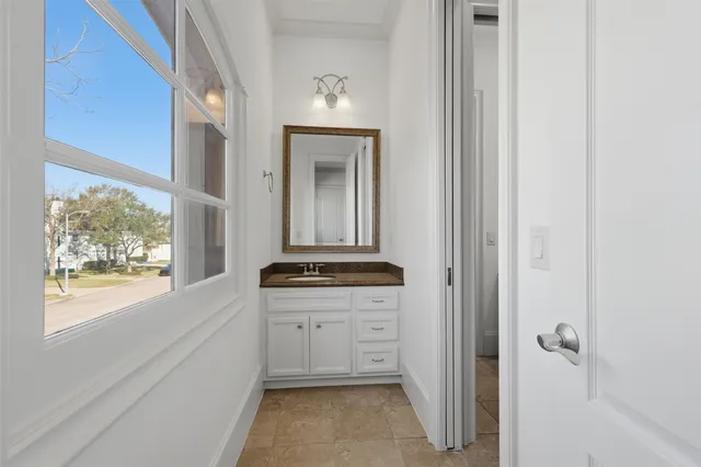 a bathroom with a granite countertop sink a mirror and a bathtub
