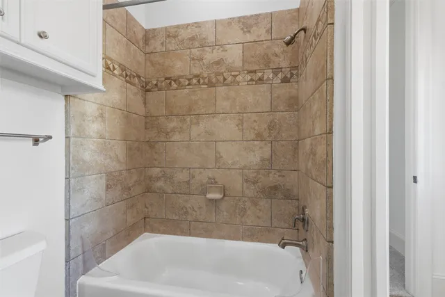 a bath tub sitting next to a white sink