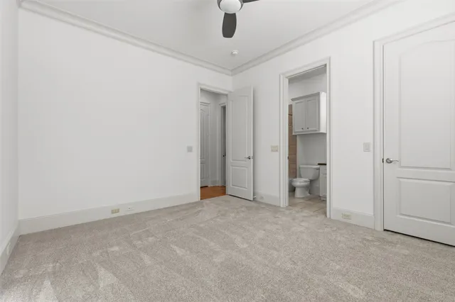 an empty room with closet and a hallway