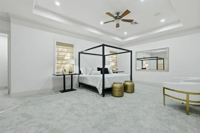 a bedroom with a bed a couch and window