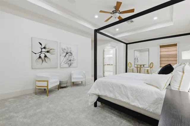 a bedroom with a large bed and a chandelier