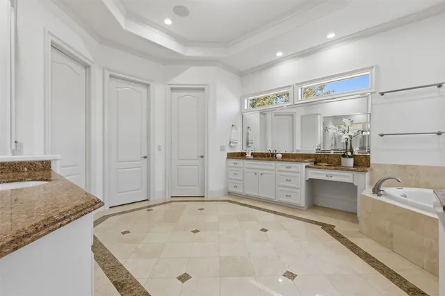 a spacious bathroom with a granite countertop tub sink and mirror
