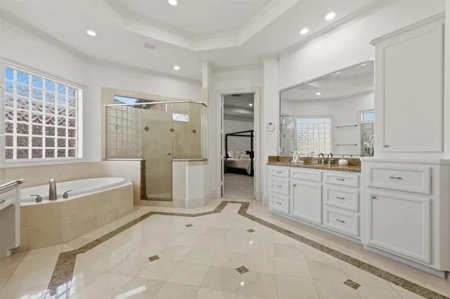 a large bathroom with a tub sink shower and mirror