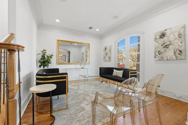 a living room with furniture and a painting on the wall