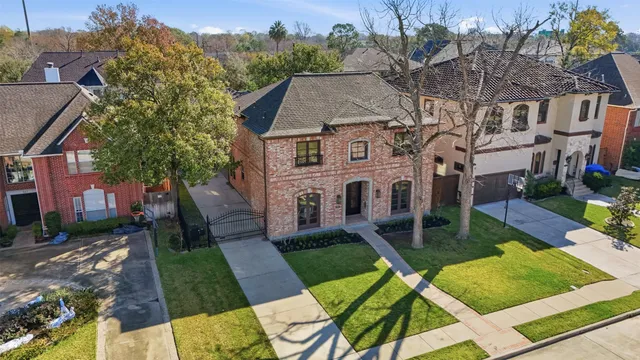 a aerial view of a house with a yard patio and furniture