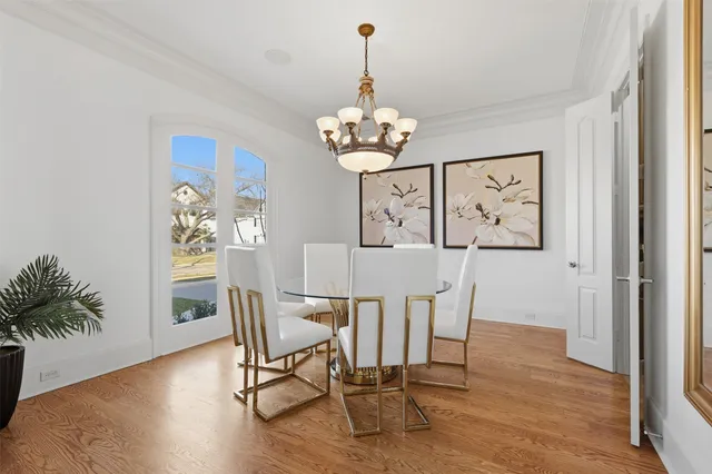 a view of a dining room with furniture wooden floor and a chandelier