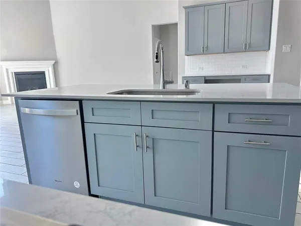 a kitchen with a sink and cabinets