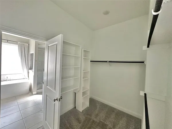 a bathroom with a shower and a glass door