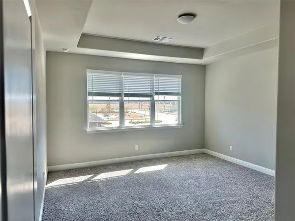 an empty room with a empty space and windows