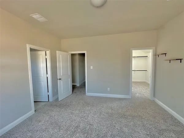 a view of an empty room and closet area