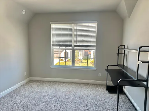 a view of yellow house with swimming pool in front of it
