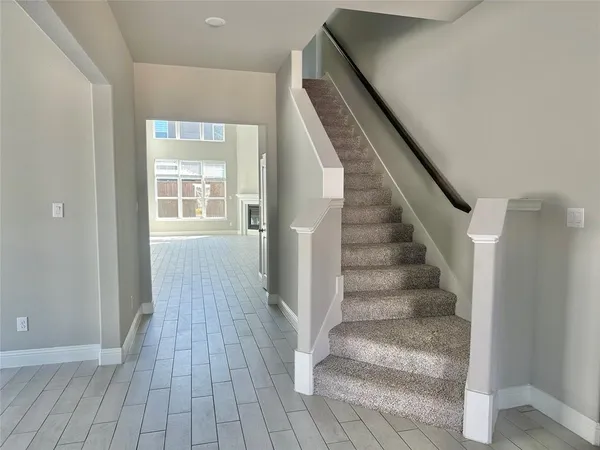 a view of entryway with wooden floor and stairs