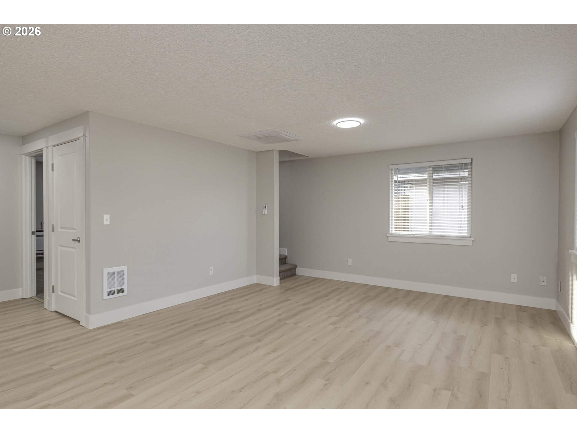 601 West 1st Street, Unit 13 Newberg, OR 97132 - Photo 11 of 30 a view of an empty room with wooden floor and a window