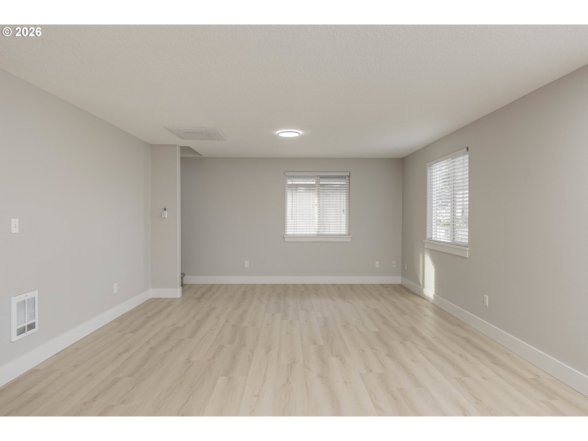 601 West 1st Street, Unit 13 Newberg, OR 97132 - Photo 12 of 30 a view of an empty room with a window and wooden floor