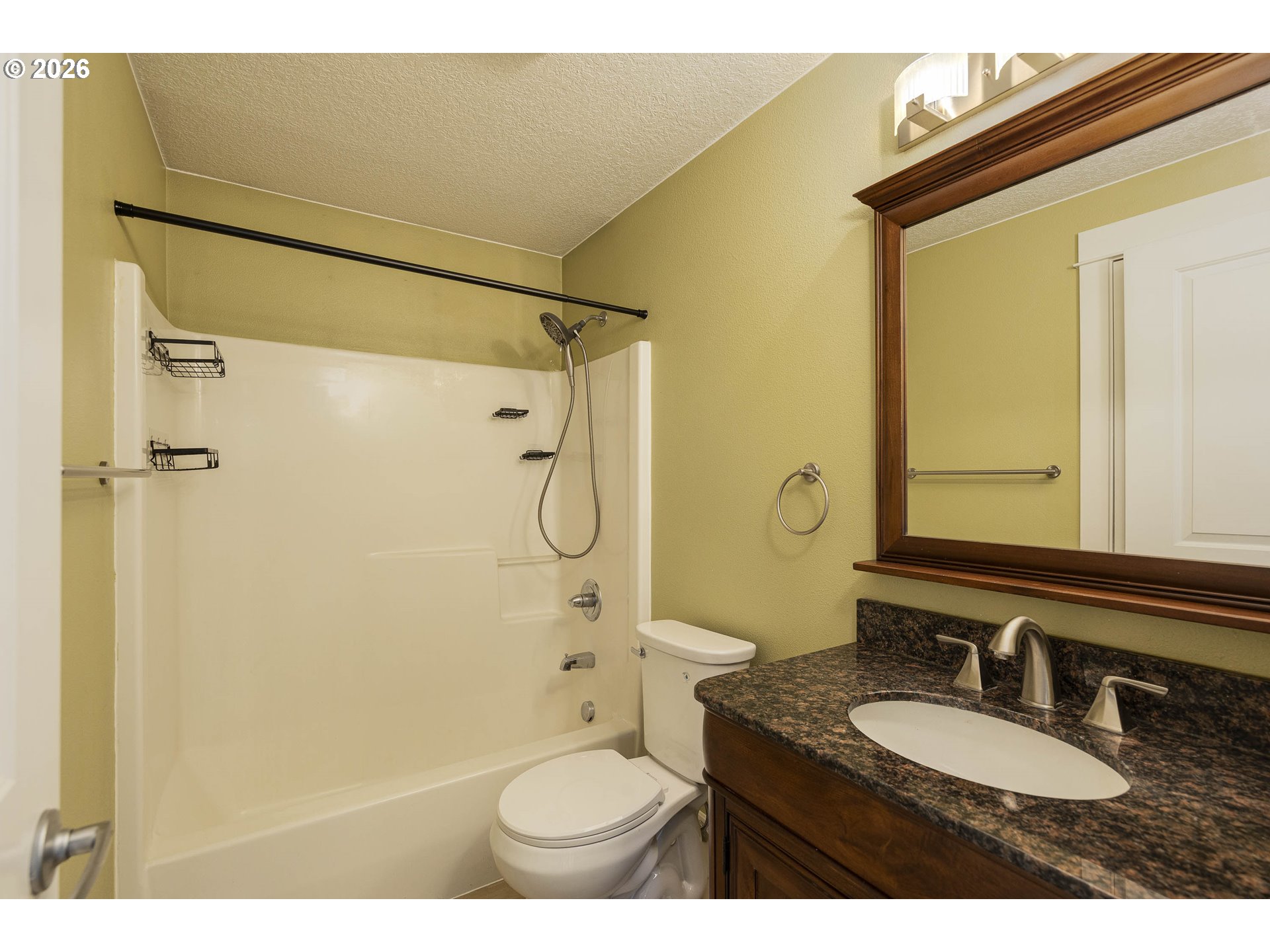 601 West 1st Street, Unit 13 Newberg, OR 97132 - Photo 17 of 30 a bathroom with a granite countertop sink toilet mirror and shower