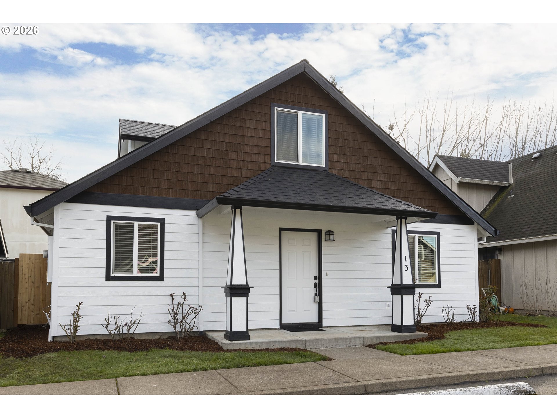 601 West 1st Street, Unit 13 Newberg, OR 97132 - Photo 2 of 30 a front view of a house with a yard