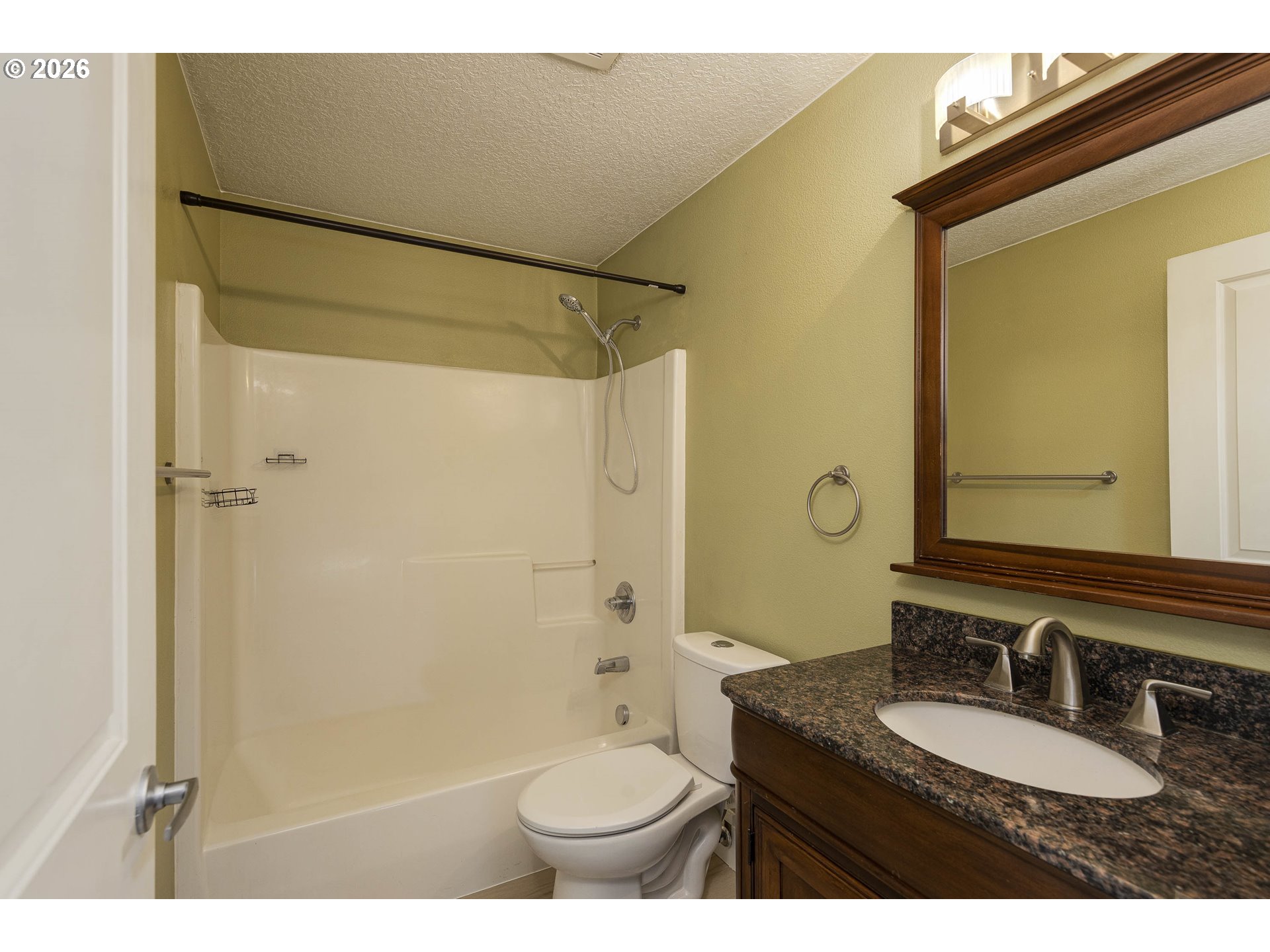 601 West 1st Street, Unit 13 Newberg, OR 97132 - Photo 24 of 30 a bathroom with a granite countertop sink toilet mirror and shower