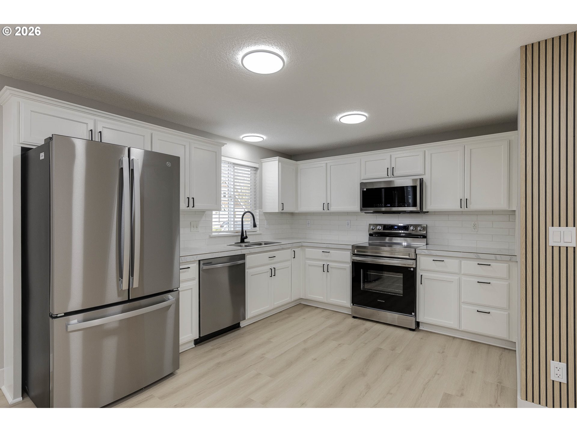 601 West 1st Street, Unit 13 Newberg, OR 97132 - Photo 7 of 30 a kitchen with stainless steel appliances a refrigerator sink and microwave