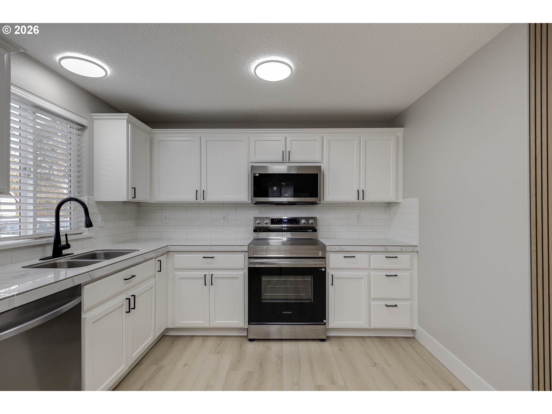 601 West 1st Street, Unit 13 Newberg, OR 97132 - Photo 8 of 30 a kitchen with sink a stove and cabinets