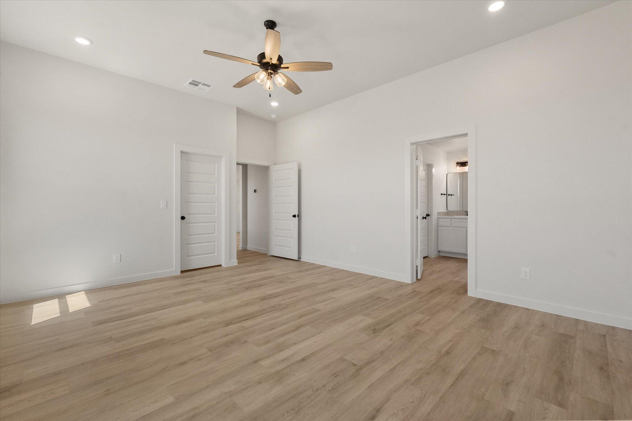 1203 East 30th Street Wolfforth, TX 79382 - Photo 15 of 25 a view of an empty room with wooden floor
