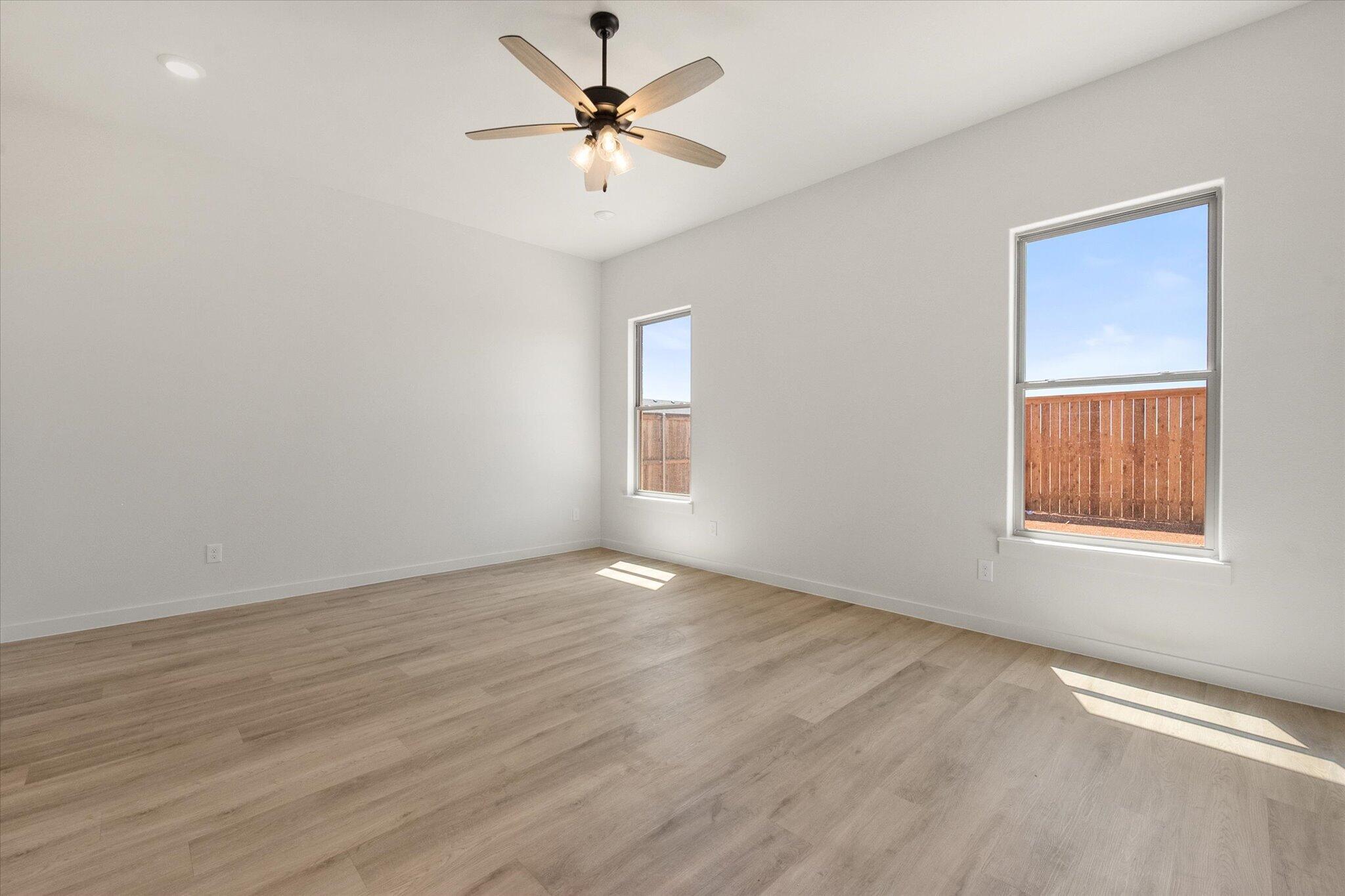 1203 East 30th Street Wolfforth, TX 79382 - Photo 16 of 25 wooden floor in an empty room with a window