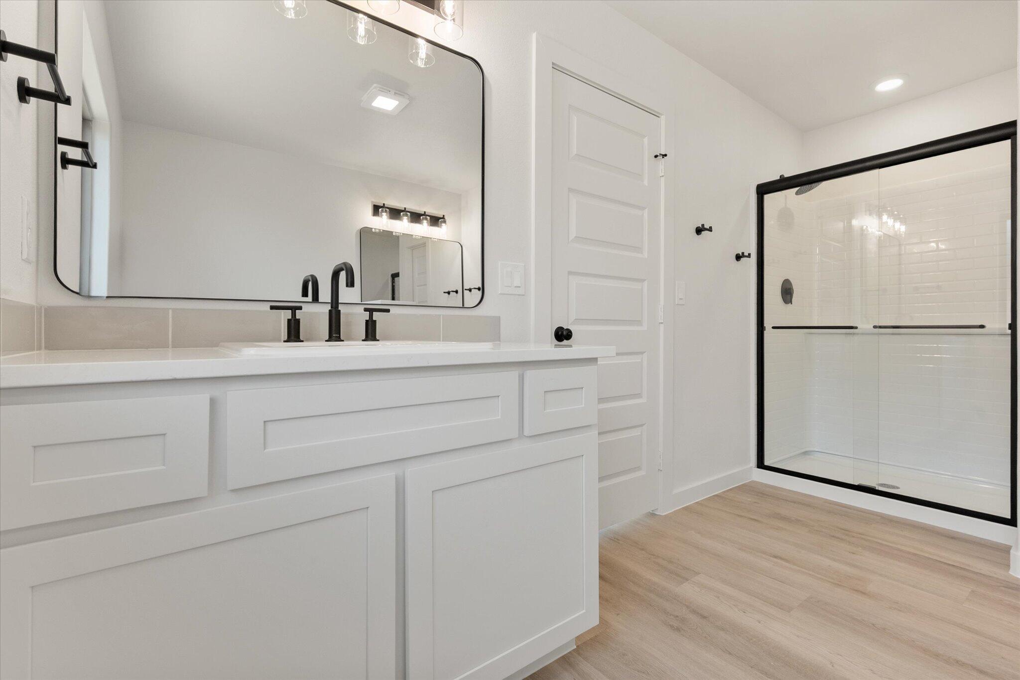 1203 East 30th Street Wolfforth, TX 79382 - Photo 17 of 25 a bathroom with a sink and a mirror