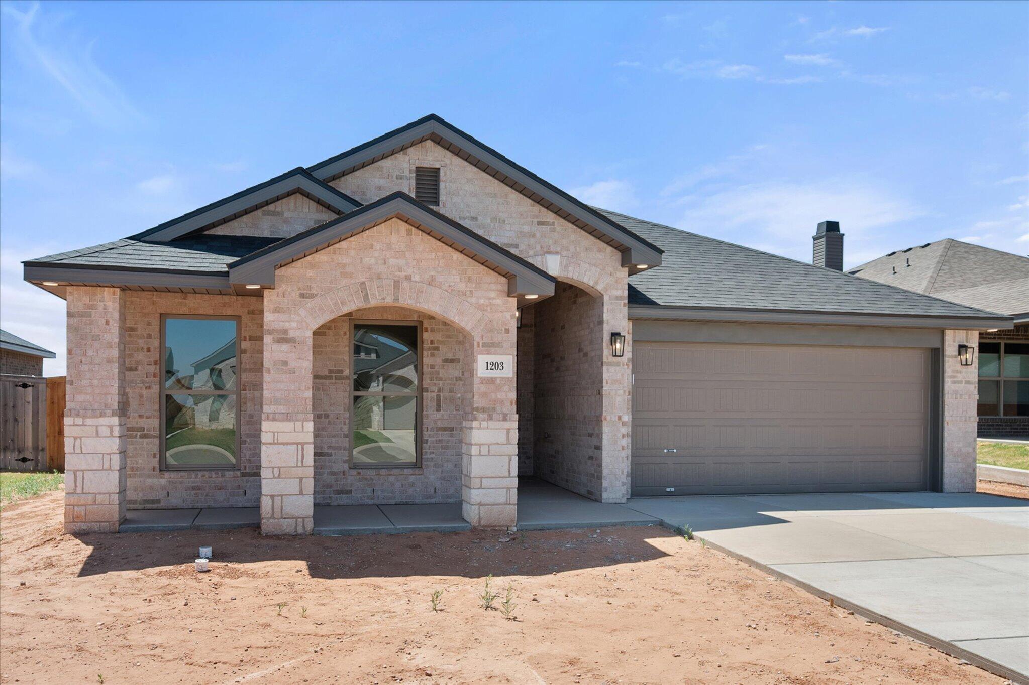 1203 East 30th Street Wolfforth, TX 79382 - Photo 2 of 25 a front view of a house with a yard
