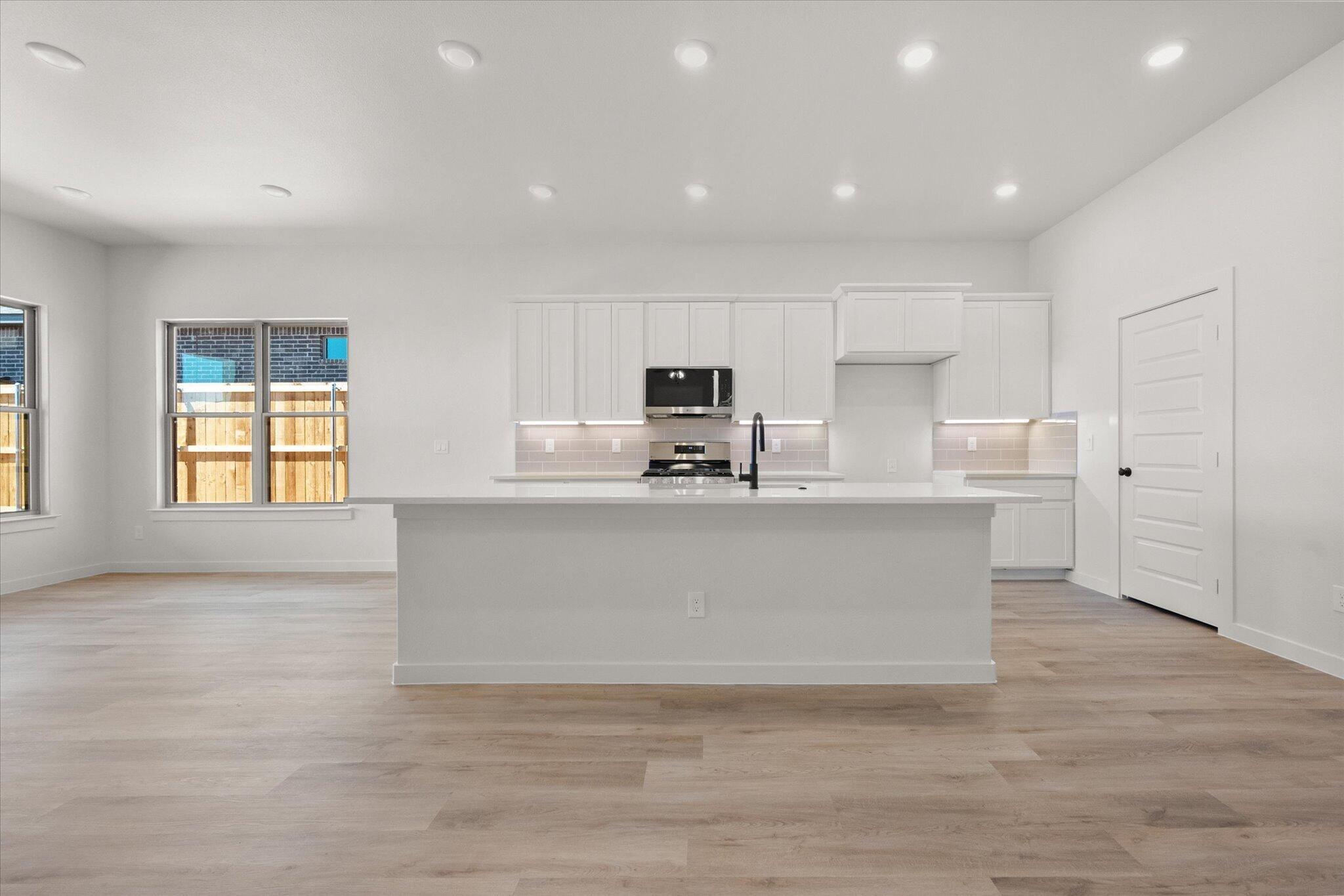 1203 East 30th Street Wolfforth, TX 79382 - Photo 8 of 25 a view of kitchen with kitchen island white cabinets and stainless steel appliances