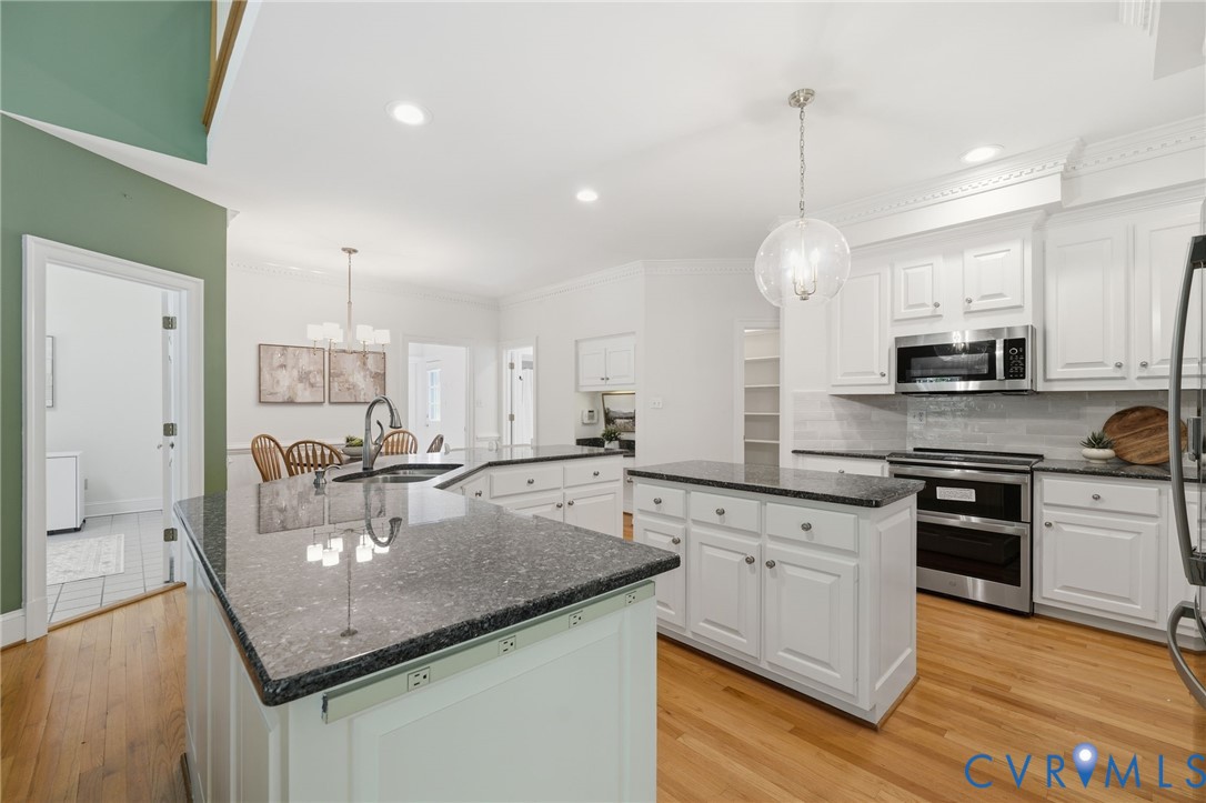 10424 Windam Hill Road Glen Allen, VA 23059 - Photo 19 of 69 a kitchen with stainless steel appliances granite countertop a sink a stove and a wooden floors