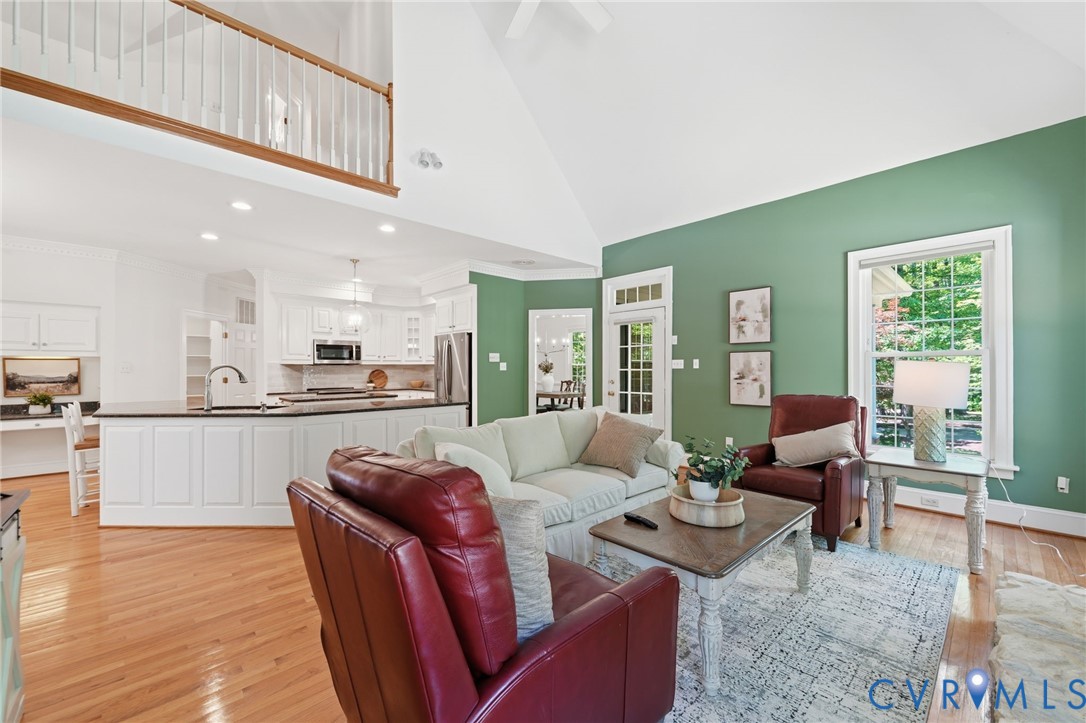 10424 Windam Hill Road Glen Allen, VA 23059 - Photo 23 of 69 a living room with furniture wooden floor and kitchen view