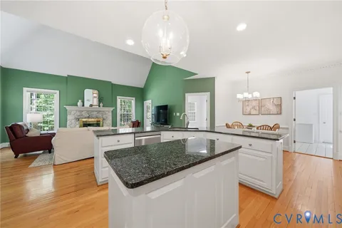 a large white bathroom with a granite countertop sink mirror and bathtub