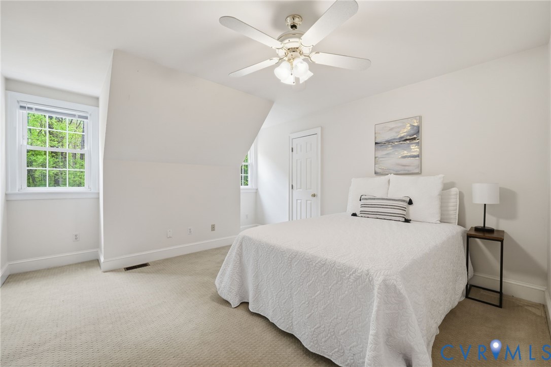 10424 Windam Hill Road Glen Allen, VA 23059 - Photo 33 of 69 a spacious bedroom with a bed and a chandelier