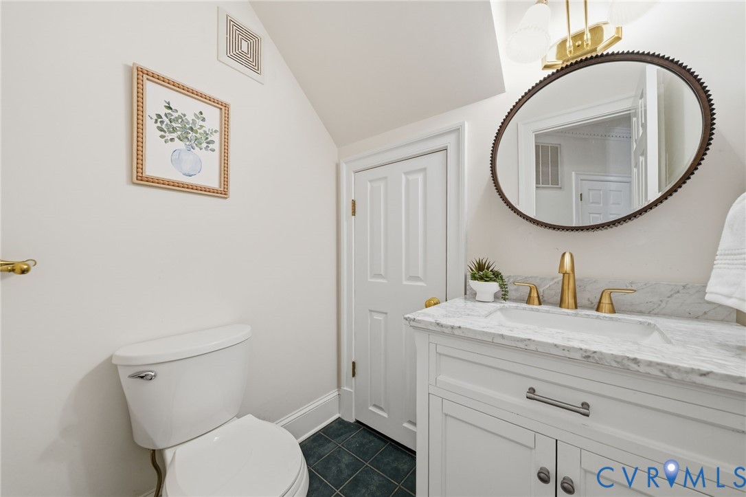 10424 Windam Hill Road Glen Allen, VA 23059 - Photo 35 of 69 a bathroom with a toilet a sink and a mirror