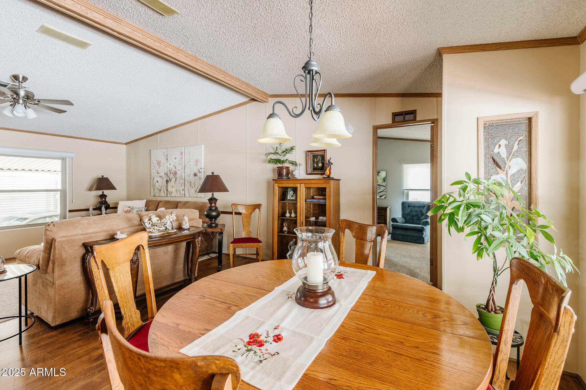 6770 West State Rte 89A, Unit 41 Sedona, AZ 86336 - Photo 11 of 31 a view of a dining room and livingroom with furniture wooden floor a chandelier