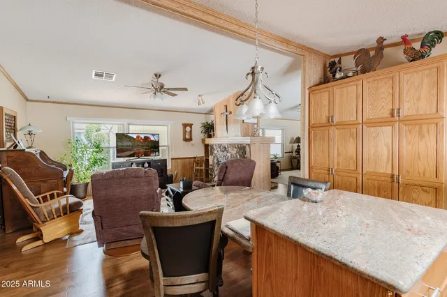 a living room with furniture a flat screen tv and a large window