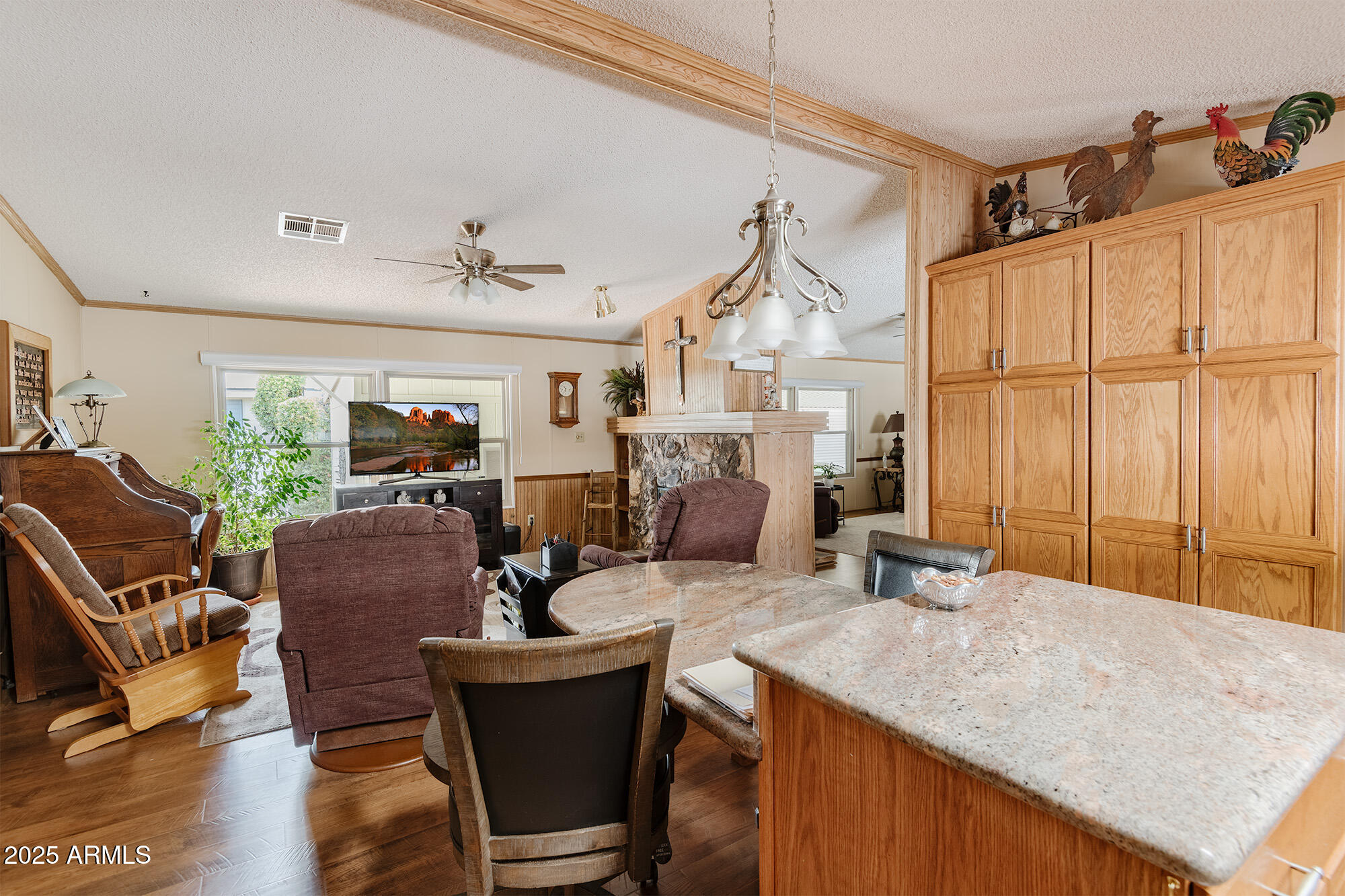 6770 West State Rte 89A, Unit 41 Sedona, AZ 86336 - Photo 21 of 31 a living room with furniture a flat screen tv and a large window