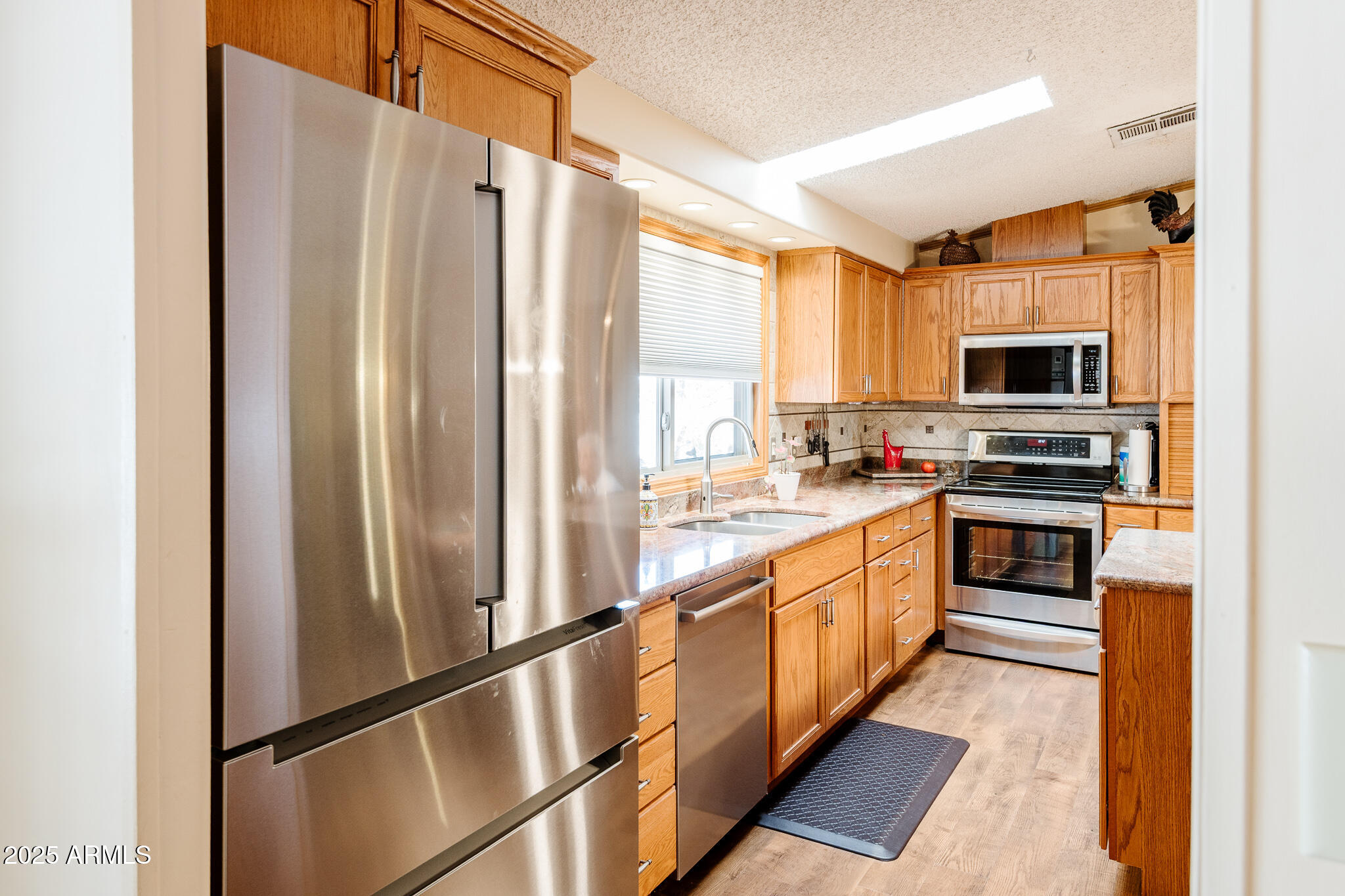 6770 West State Rte 89A, Unit 41 Sedona, AZ 86336 - Photo 22 of 31 a kitchen with stainless steel appliances granite countertop a refrigerator and a stove top oven
