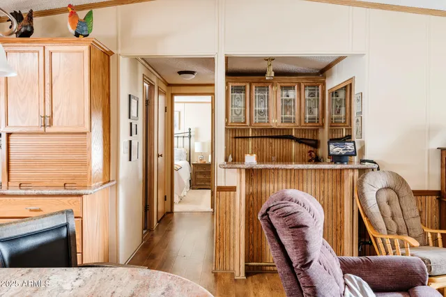 a view of living room kitchen with furniture and wooden floor