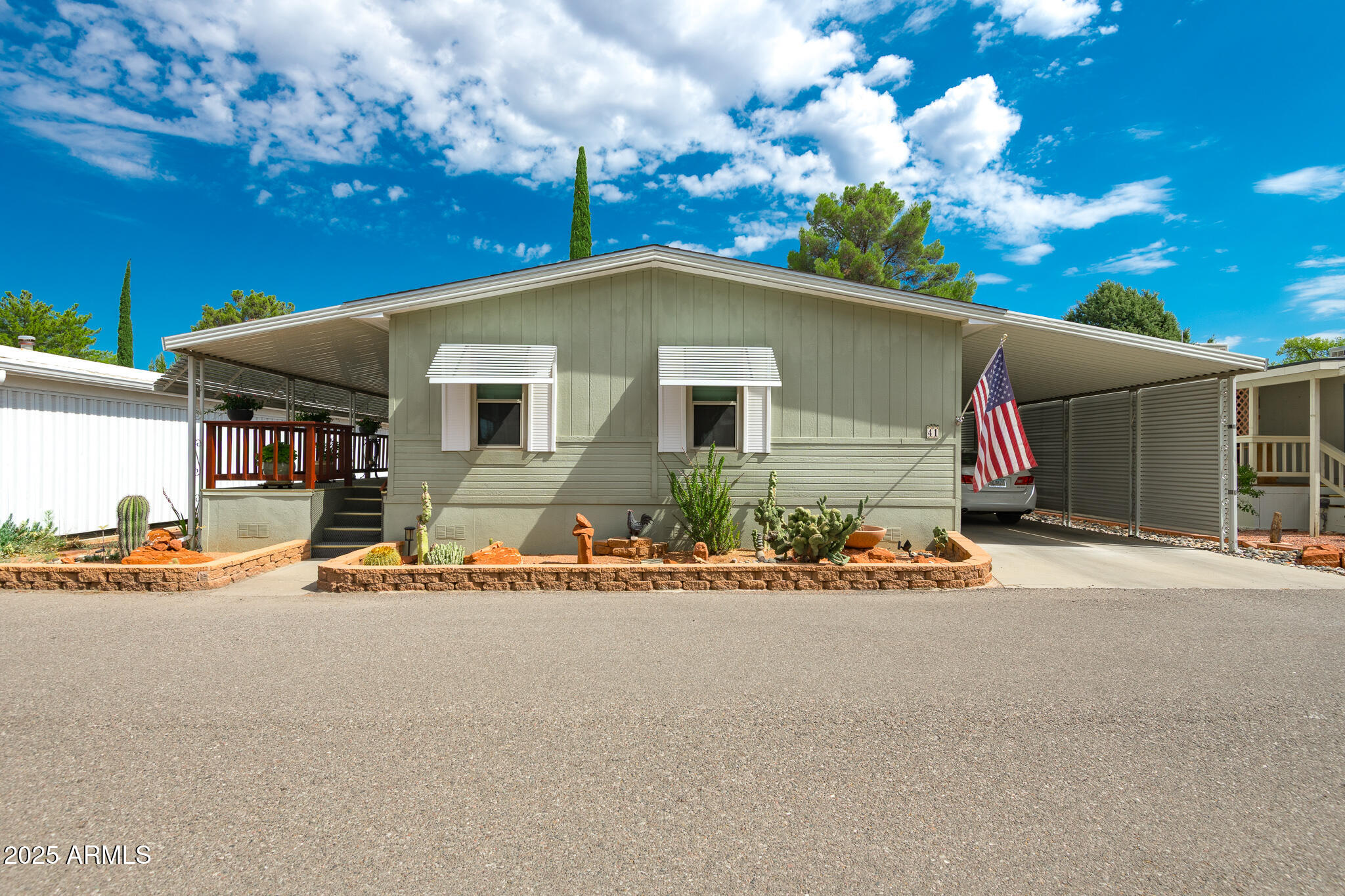 6770 West State Rte 89A, Unit 41 Sedona, AZ 86336 - Photo 4 of 31 a front view of a house with a yard and garage