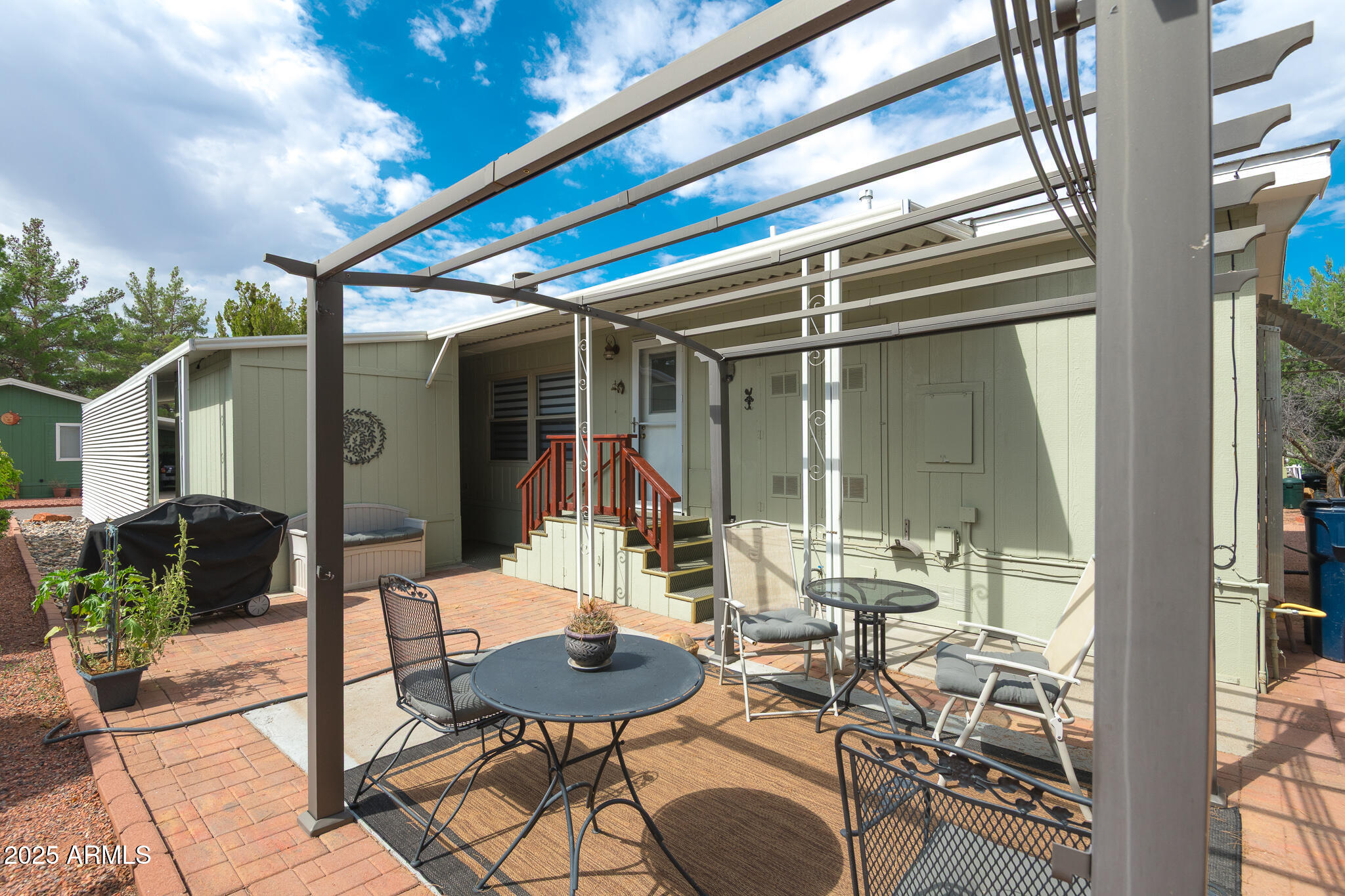 6770 West State Rte 89A, Unit 41 Sedona, AZ 86336 - Photo 7 of 31 a view of a patio with table and chairs potted plants with wooden floor