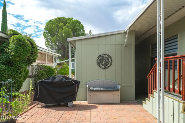 a wooden bench sitting in front of a building