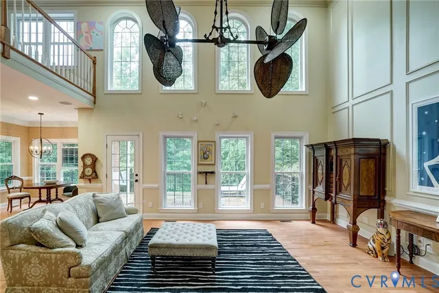 a living room with furniture a rug and a large window
