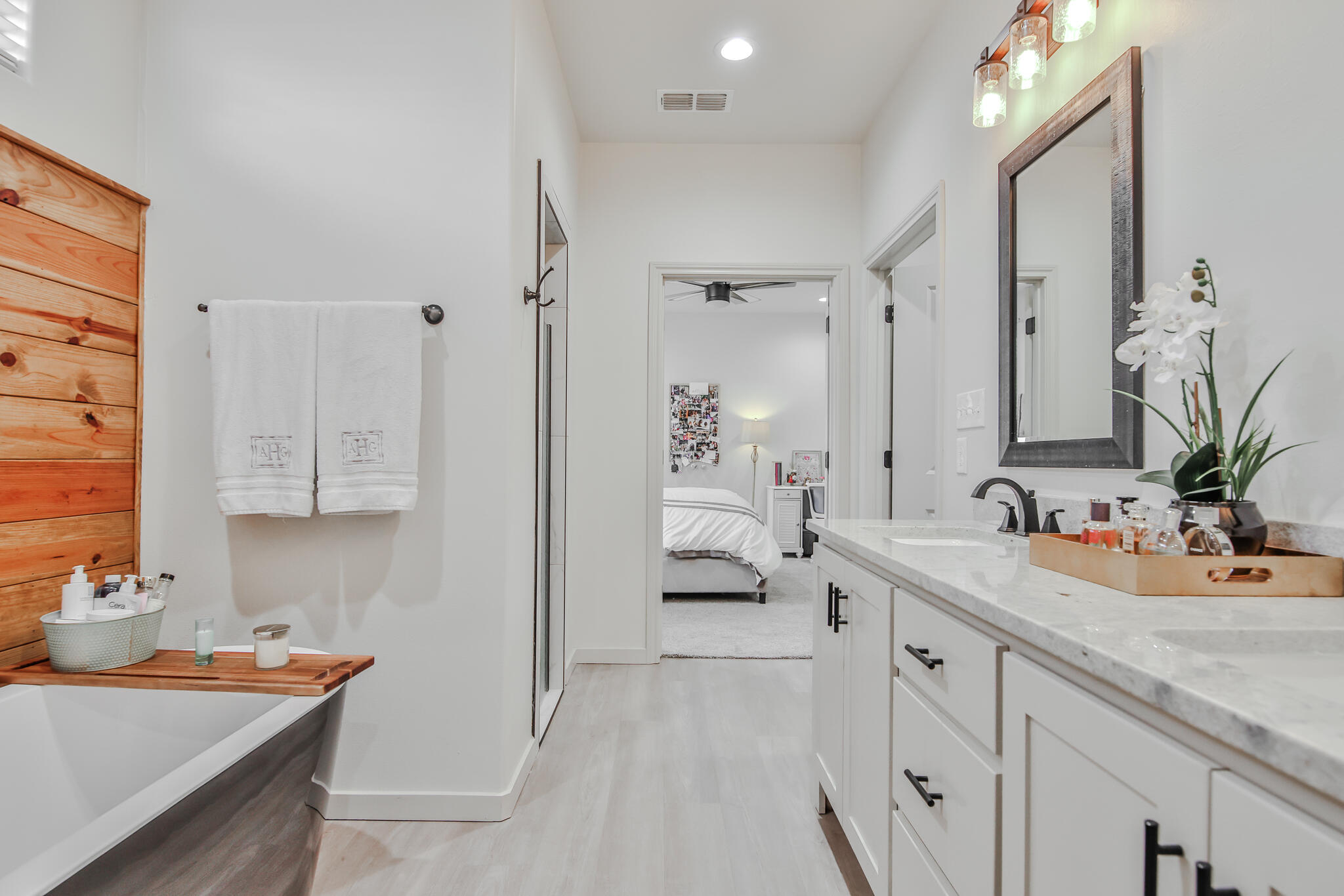 3806 59th Street Lubbock, TX 79413 - Photo 20 of 38 a bathroom with a sink a potted plant and a mirror