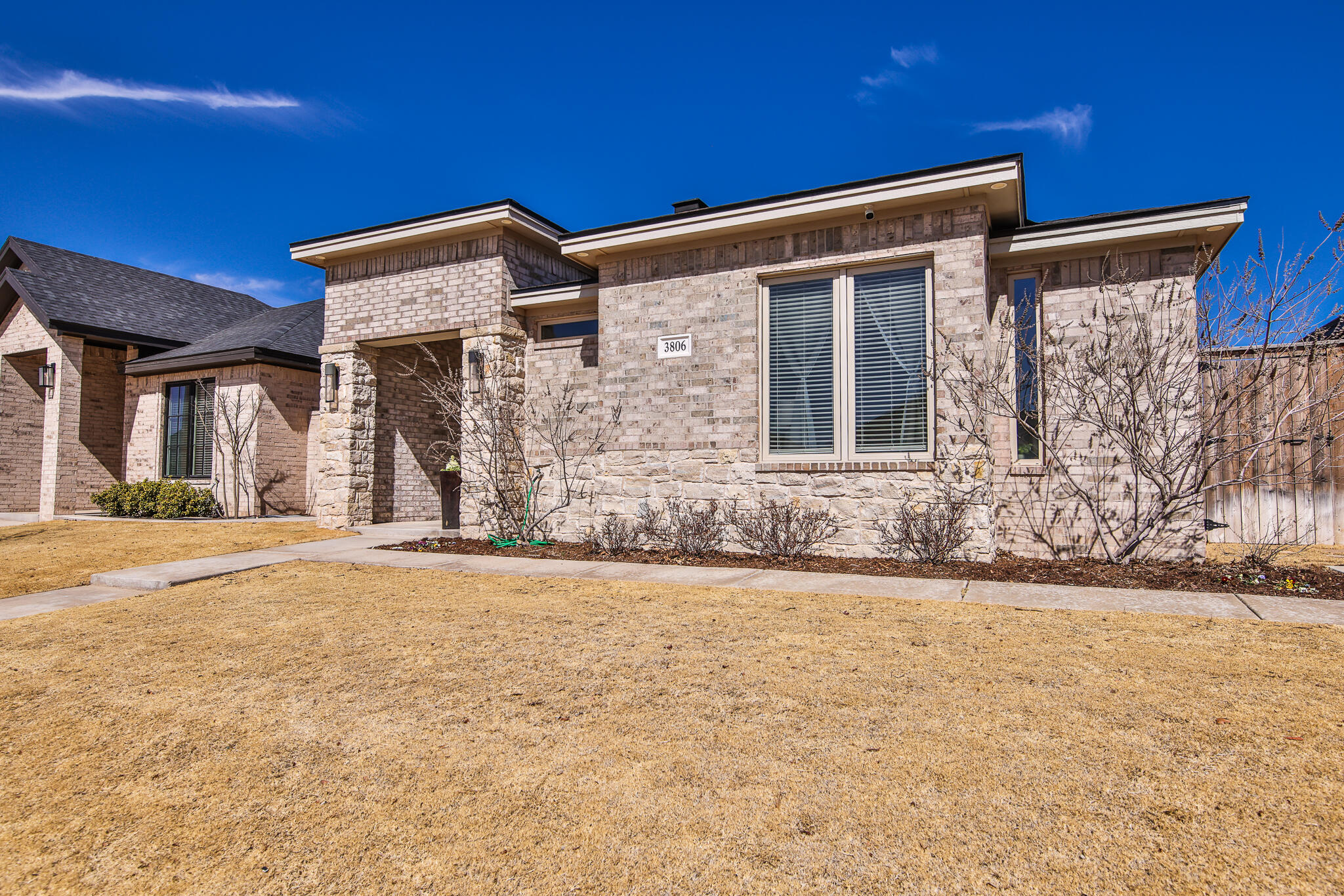 3806 59th Street Lubbock, TX 79413 - Photo 2 of 38 front view of a house with a yard