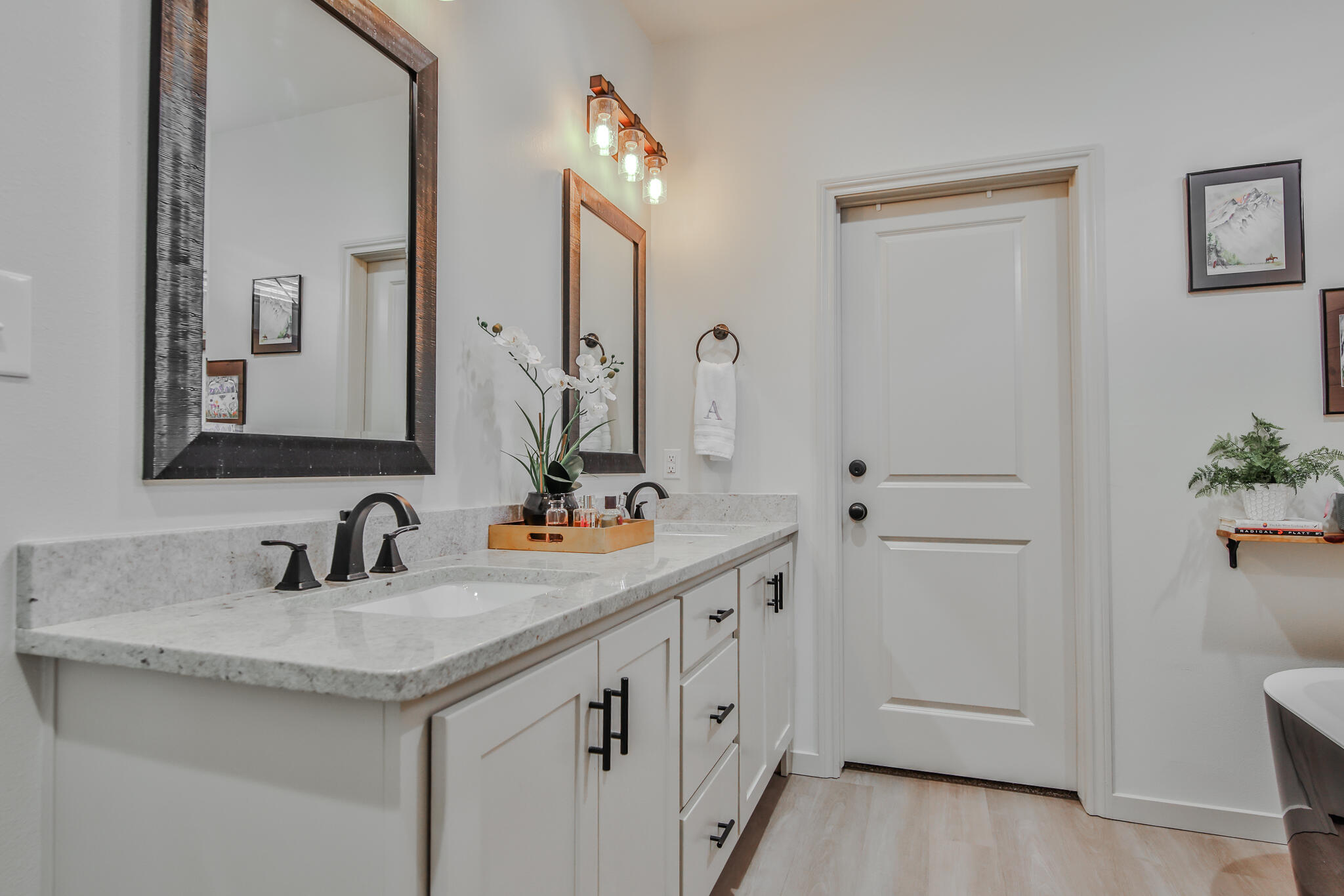 3806 59th Street Lubbock, TX 79413 - Photo 21 of 38 a bathroom with a double vanity sink and mirror