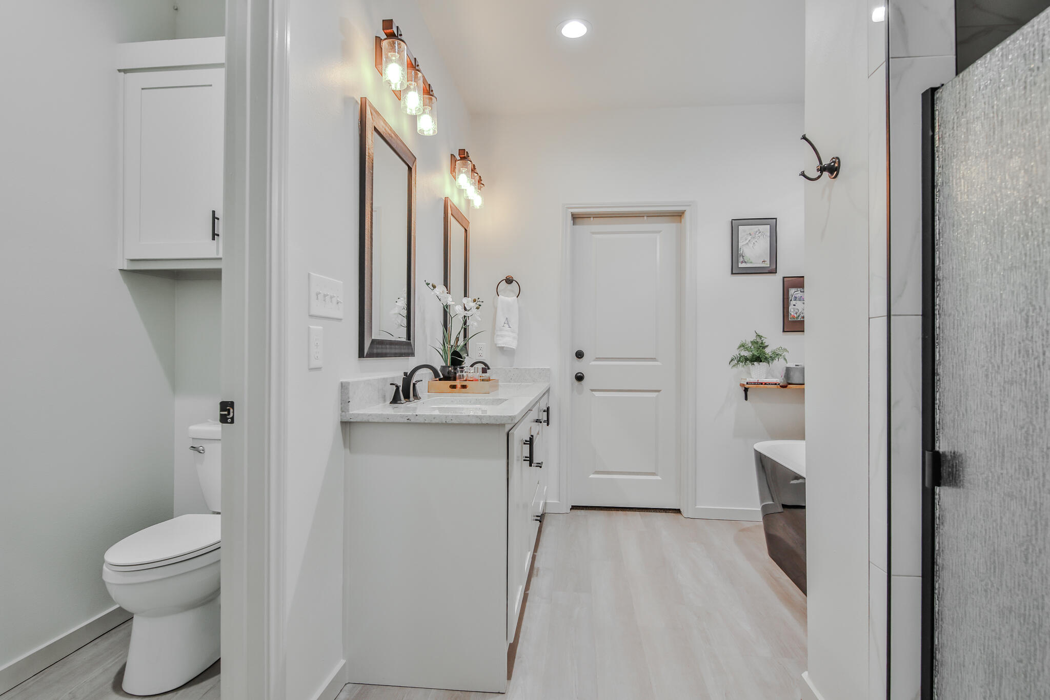 3806 59th Street Lubbock, TX 79413 - Photo 22 of 38 a bathroom with a sink a toilet and shower