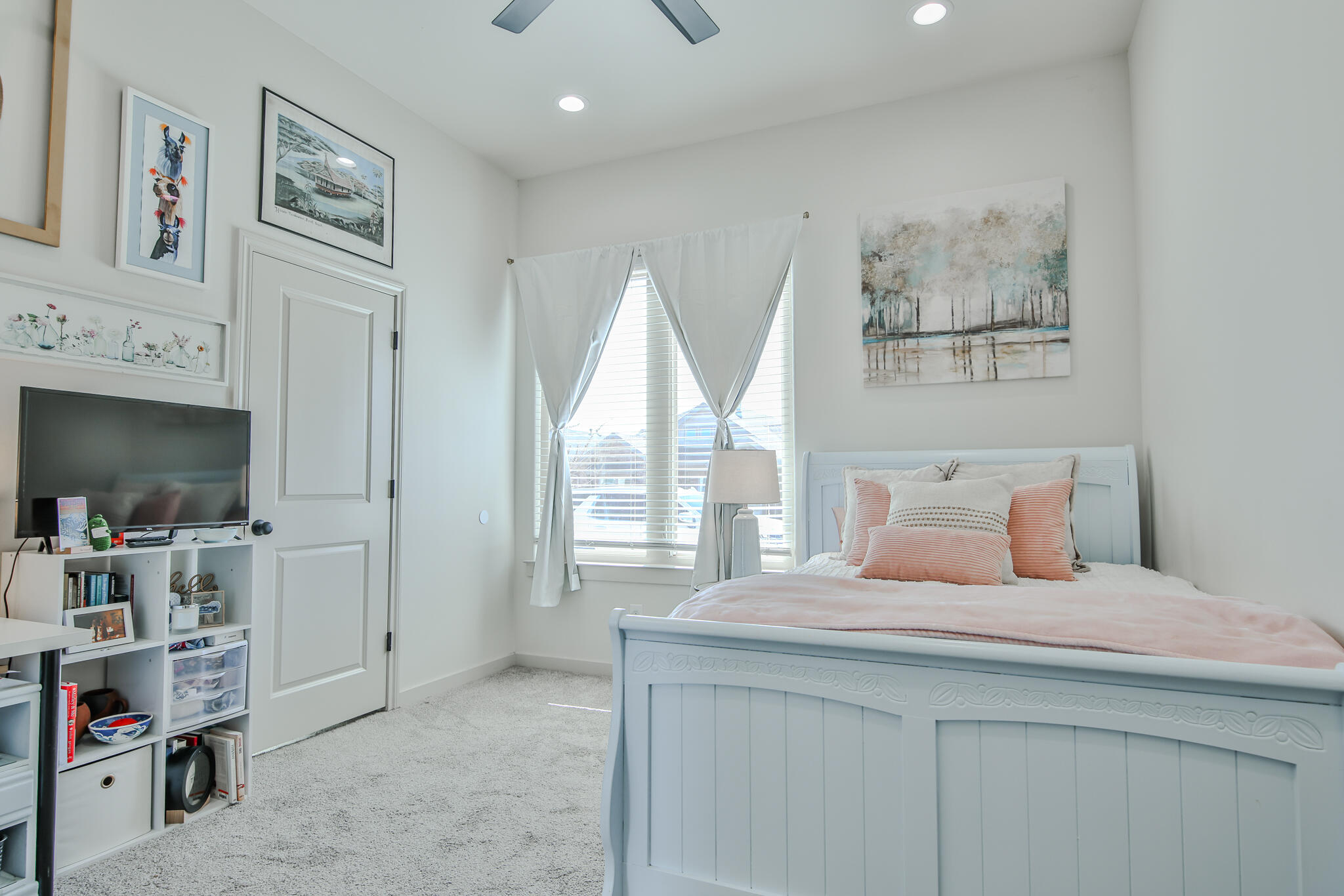 3806 59th Street Lubbock, TX 79413 - Photo 28 of 38 a bedroom with a bed and a flat screen tv