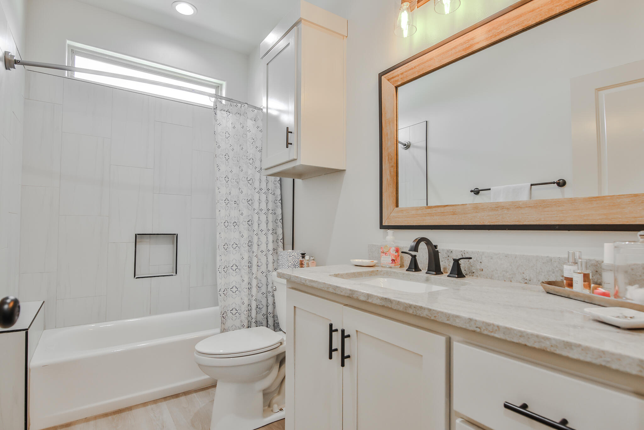 3806 59th Street Lubbock, TX 79413 - Photo 30 of 38 a bathroom with a sink a toilet and a mirror