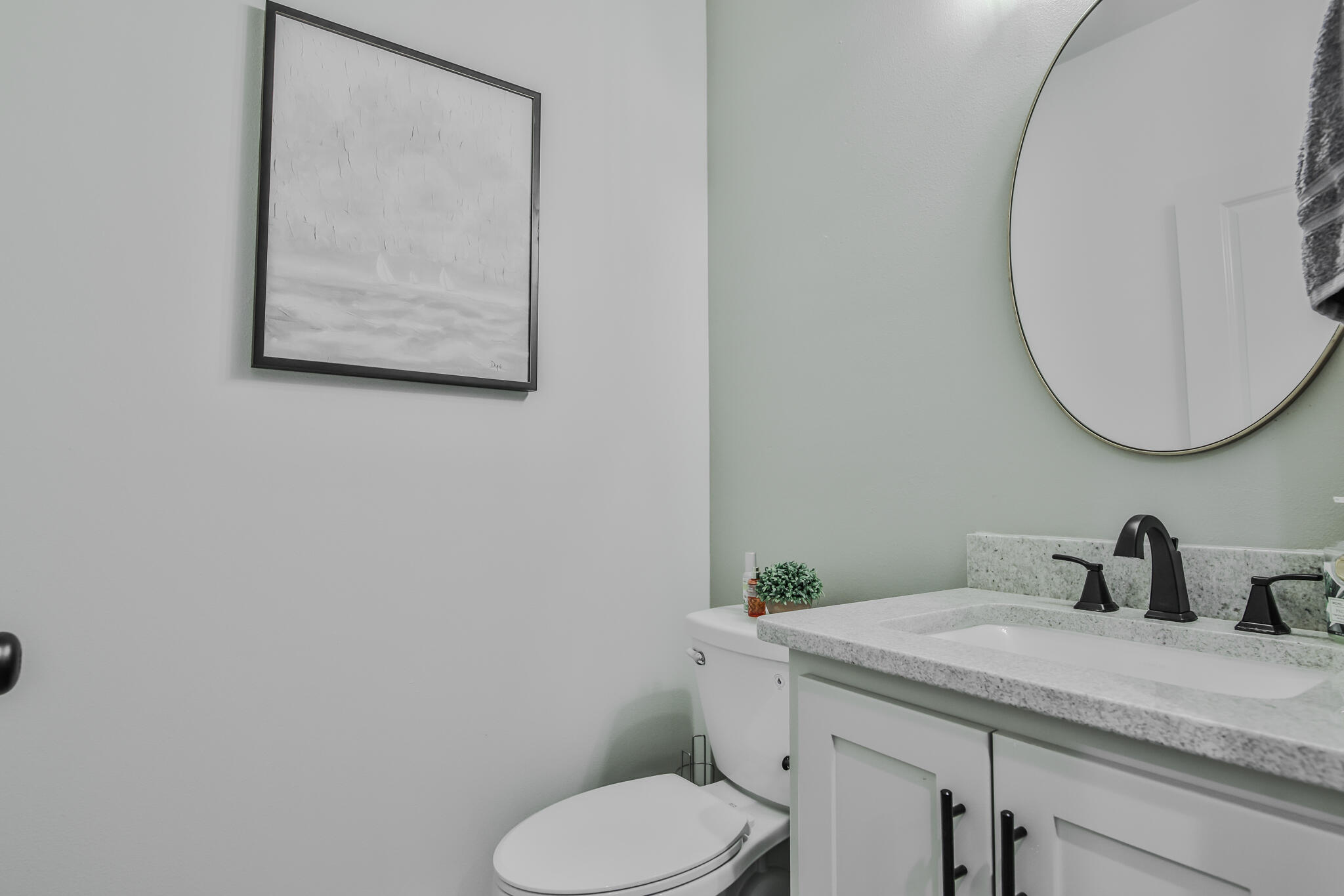 3806 59th Street Lubbock, TX 79413 - Photo 32 of 38 a bathroom with a toilet sink and mirror